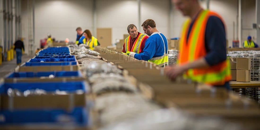 Reverse-logistics warehouse sorting returned merchandise into separated material streams
