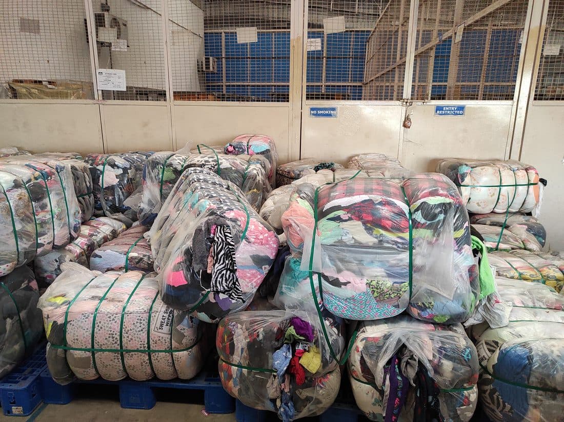 Compressed bales of sorted textiles at a recycling facility